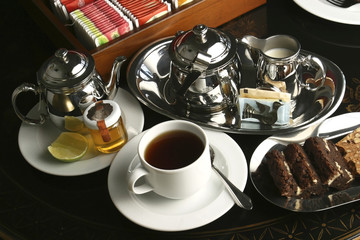 The Afternoon tea with lemon tea, honey, and walnut cookies.        Afternoon Tea is a tea-related ritual, introduced in Britain in the early 1840s and is a meal composed of sweet pastries and cakes.