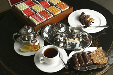 The Afternoon tea with lemon tea, honey, and walnut cookies.        Afternoon Tea is a tea-related ritual, introduced in Britain in the early 1840s and is a meal composed of sweet pastries and cakes.