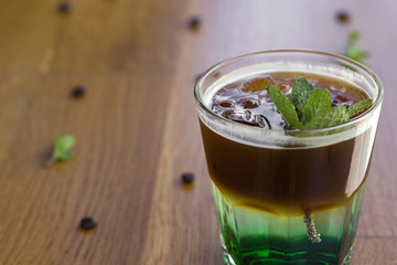Cold coffee with mint leaves and ice cubes