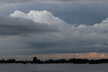 Fototapeta na wymiar Clouds over the flooded paddy fields.