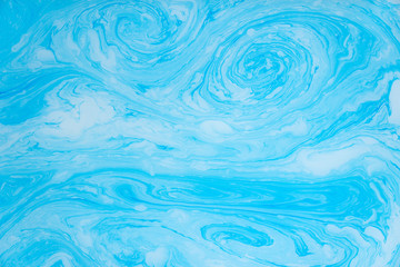 Abstract blue marble background. Stains of paint on the water.