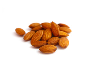 A pile of almond nuts macro view, isolated on white background.