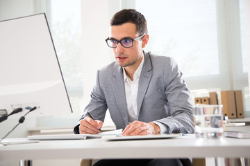 Young handsome businessman working in an office