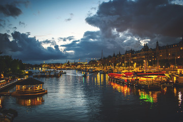 Stockholm skyline at night from the harbor Stockholm canal at down with dramatic sky 