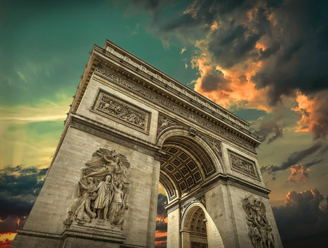 Triumphal Arch in Paris under sky with clouds. One of symbols  