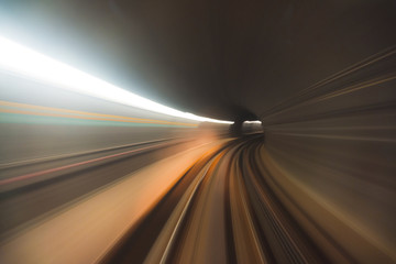 Obraz na płótnie Canvas Blurred high speed motion of a train travelling through a tunnel