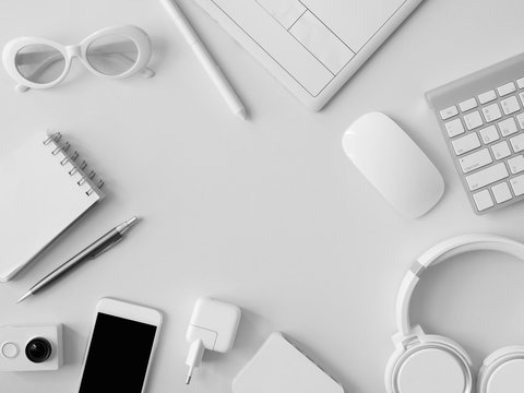 top view of office desk workspace with smartphone, notebook, graphic tablet, keyboard and mouse on grey color background, graphic designer, Creative Designer concept. - Powered by Adobe