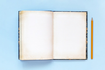 Blank open Notepad and pencil. empty notebook on blue background. Copy space