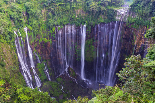 Majestic view of Tumpak Sewu Waterfall or also known as Coban Sewu, is a waterfall with 120 metres high, located in Sidomulyo Village, Pronojiwo District, Lumajang Regency, East Java, Indonesia.