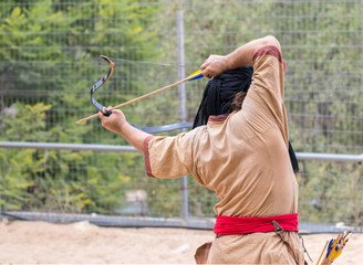 The participants of the festival in traditional costume of the Saracen warrior show the art of...