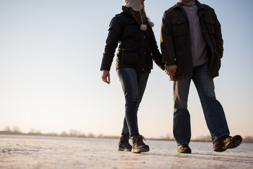 Couple taking a romantic walk on frozen lake