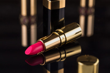 Lipstick. Fashion Colorful Lipsticks over black background. Professional Makeup and Beauty. Beautiful Make-up concept. Lipgloss. Lipsticks closeup