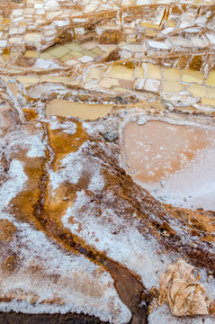 Close up of the saltpeter built in a valley on a cloudy day of Maras in Peru