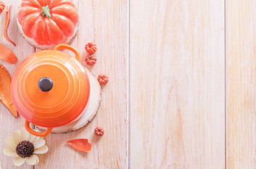 Happy Thanksgiving Day concept. Soup pot with pumpkin for autumn festive decoration on wood background.Copy space