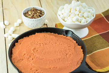 Unbaked sweet potato casserole, marshmallows and pecans for topping.