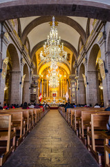 Inside of La Merced Convent with chandeliers, pulpit and altar in Cusco, Peru