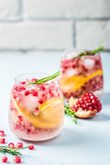 Festive drinks, citrus, pomegranate cocktail. Selective focus, space for text.