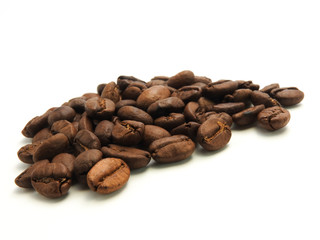 A pile of coffee beans isolated on white background.It  can be made into drinks and beverages,like latte,cappuccino, espresso.Economic crop in global trade business,agricultural products exports.