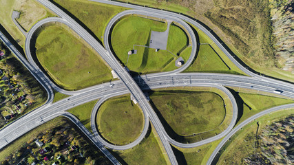 Aerial view of highway interchange  Road junction Aerial photo of a highway going through the forest