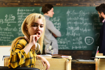 Student passing an exam euphoric girl watching a laptop in the class. Students campus education knowledge concept. Student will have to be dedicated and self-disciplined to reach his goals.