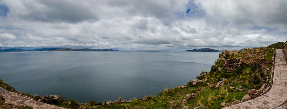 Panoramic on Taquile Island with fullview of Titikaka lake and a road on the iland