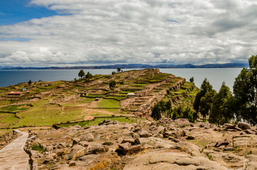 Fototapeta na wymiar Landscape of the Taquile Island with a stone road, houses and Titikaka lake