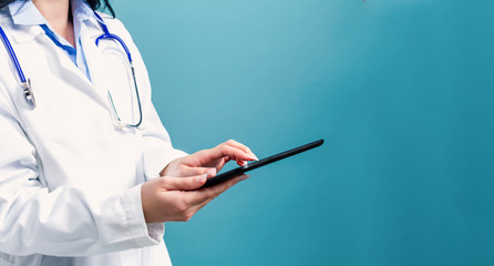 Medical doctor with digital tablet on a blue background