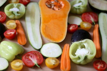 Assortment of various colorful vegetables: butternut squash, zucchini, cucumber, tomato, eggplant, pepper and carrot. Top view, selective focus.
