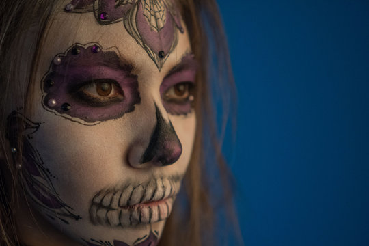 Close-up portrait of a girl with a dead man's make-up for Halloween
