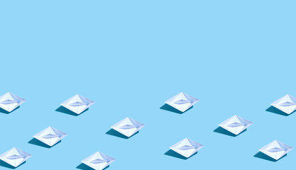 Collection of paper boats on a blue background