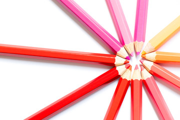 Fototapeta premium Color pencil arrange in ray shape on white paper background