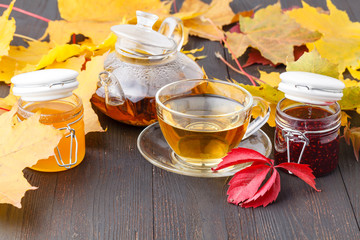 delicious tea with with sea buckthorn berries in glass cup on the table