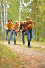 Fototapeta premium Portrait of a family of four in park