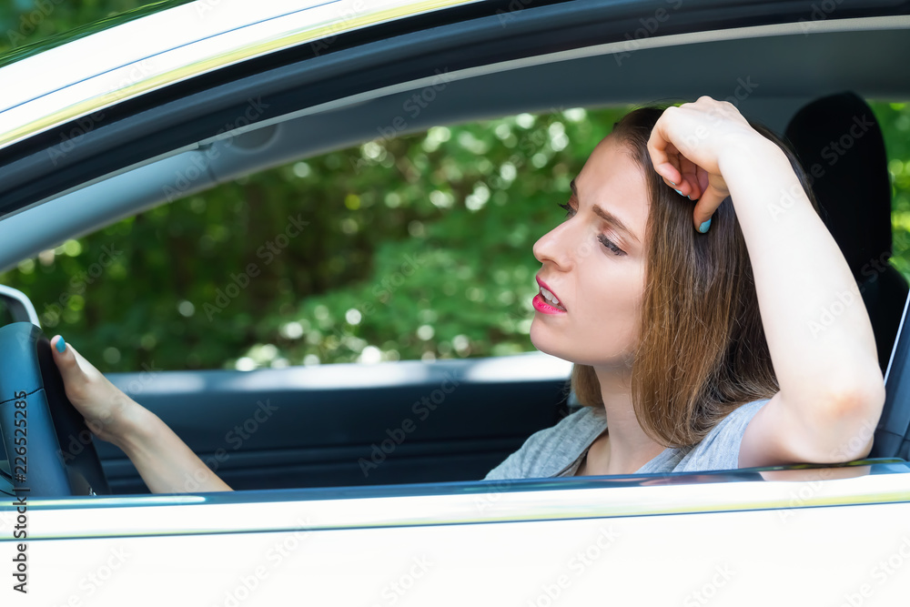 Wall mural stressed young woman upset about traffic in a new car