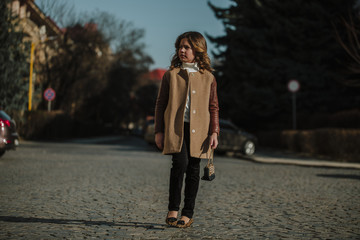 Fototapeta premium Autumn walk on a sunny day. Beautiful young lady