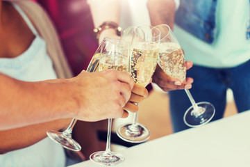 celebration, people and holidays concept - close up of friends clinking glasses of champagne at party