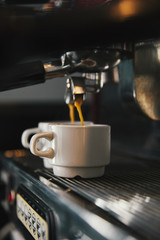 close-up view of coffee machine and two cups with espresso