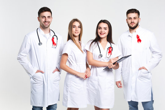 Group of doctors  with watercolor of red ribbon .world AIDS day concept. On the white background.