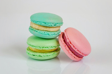 Sweet almond colorful pink, biue, yellow, green macaron or macaroon dessert cake isolated on white background. French sweet cookie. Minimal food bakery concept
