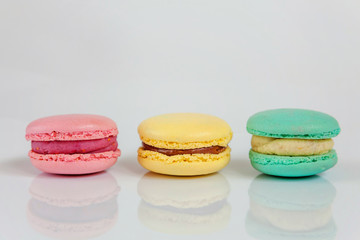 Sweet almond colorful pink, biue, yellow, green macaron or macaroon dessert cake isolated on white background. French sweet cookie. Minimal food bakery concept