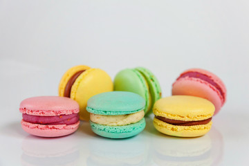 Sweet almond colorful pink, biue, yellow, green macaron or macaroon dessert cake isolated on white background. French sweet cookie. Minimal food bakery concept