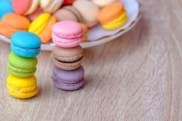 Macaron dessert and coffee on the wooden table.