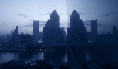 Fototapeta na wymiar Modern mirror efect abstract of building city skyline in Bangkok.