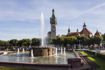 View of the fountain and the lighthouse in the background in the city of Sopot. Poland