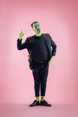 Bloody Halloween theme: The crazy maniak face on pink studio background