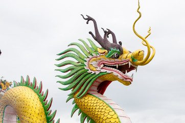 golden dragon statue in cloudy background