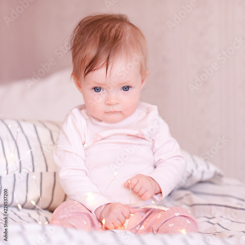Cute Baby Girl Sitting In Bed Wearing Pajamas Closeup Good Morning