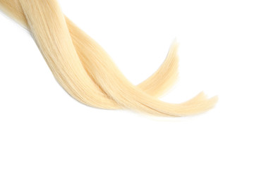 Locks of healthy blond hair on white background