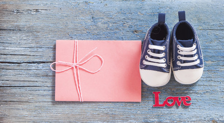 Colorful toddler shoes on wooden background