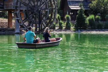Obraz premium Young couple boy and girl float on a boat